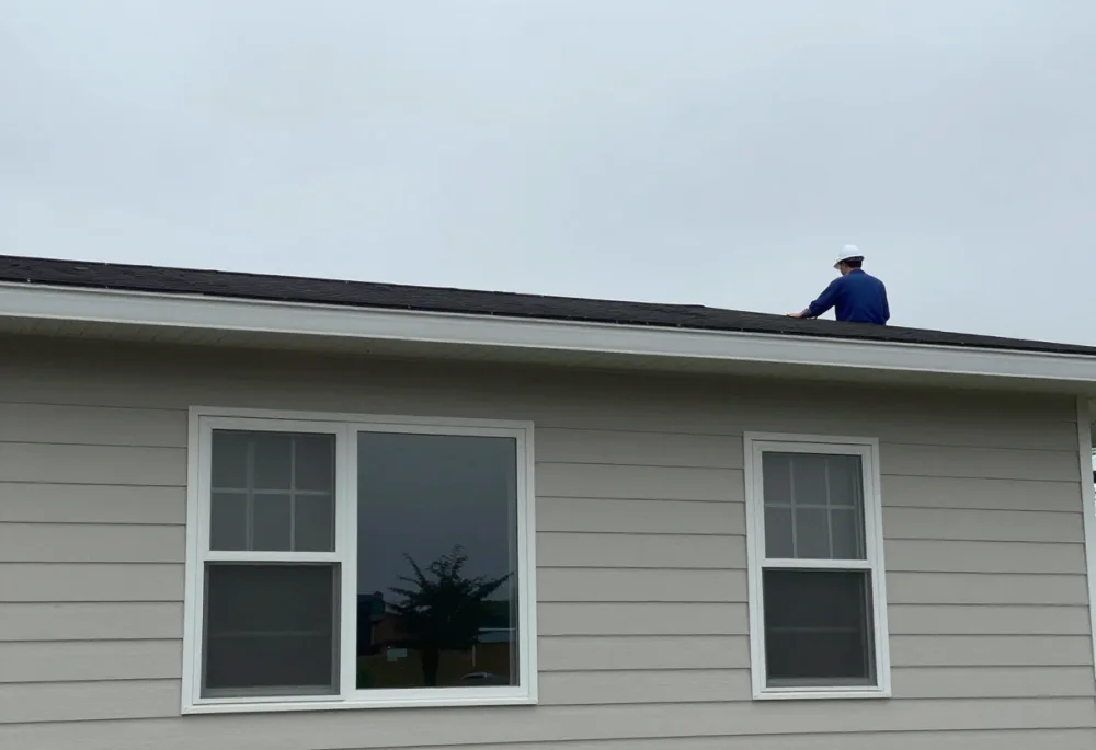Inspector examining the roof edge of a manufactured home